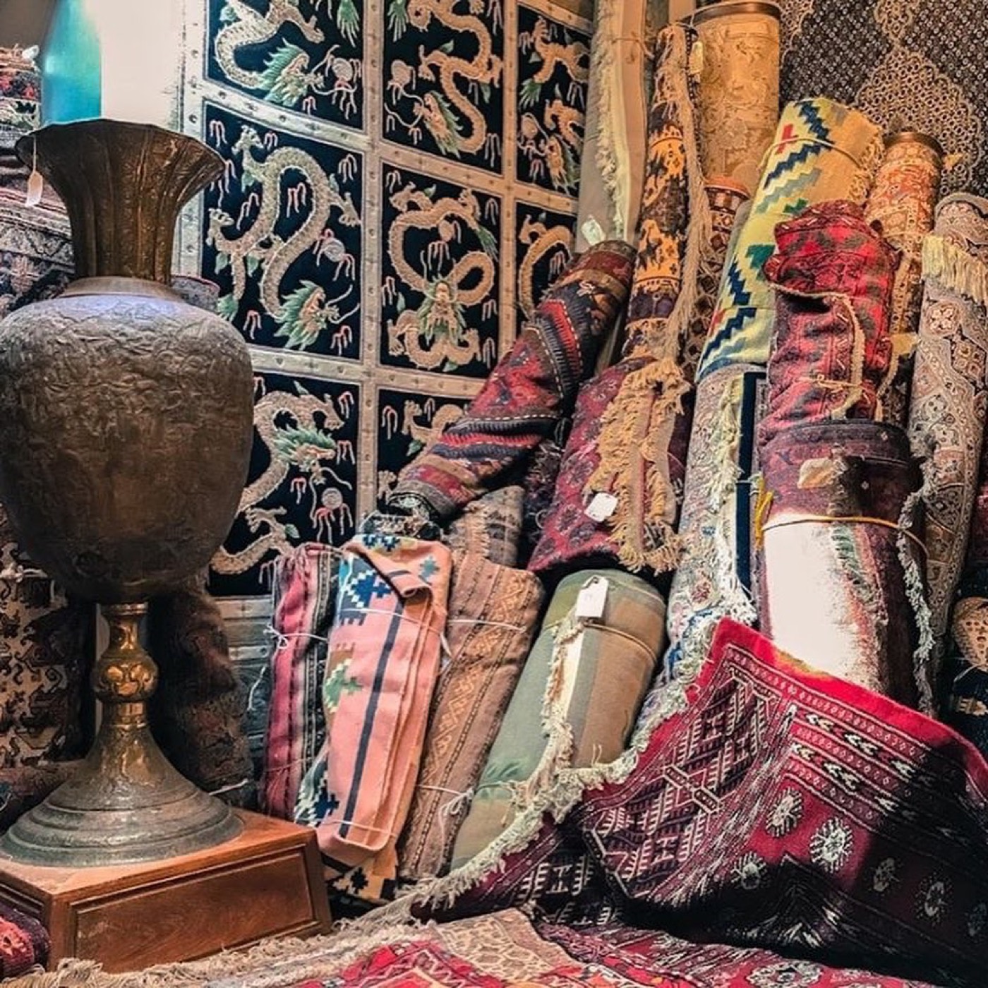 Stacked rugs and brass in the Khyber Pass Gallery showroom